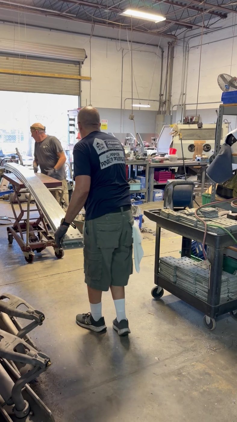 Southern Switch crew cleaning and preparing generator bus bar sections in the Palm Harbor shop during the Duke Anclote refurbishment project.