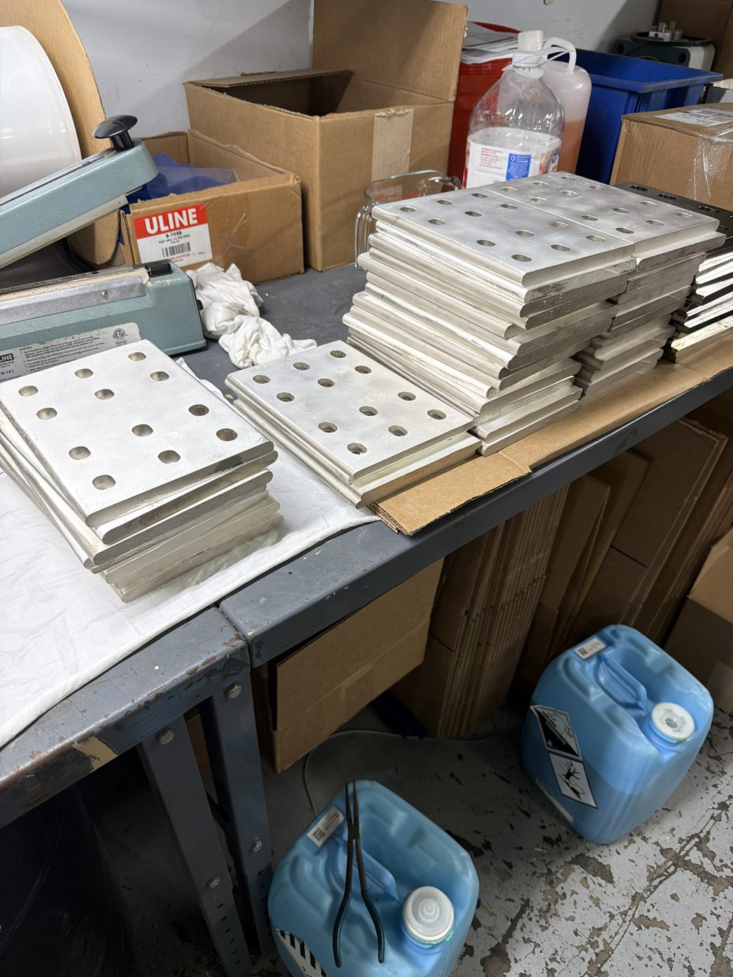 Stacks of silver-plated aluminum splice plates for Duke Anclote generator bus, freshly replated at Southern Switch shop in Palm Harbor, FL.