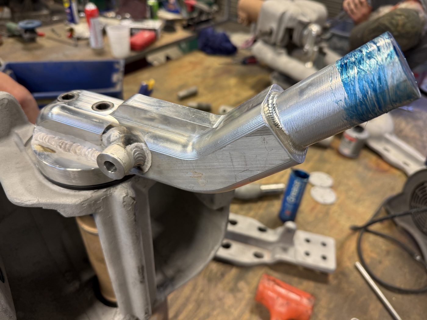 New billet aluminum operating arm being fitted to Southern States EV1 pivot housing at Southern Switch machine shop — fresh machining visible with layout dye on shaft.