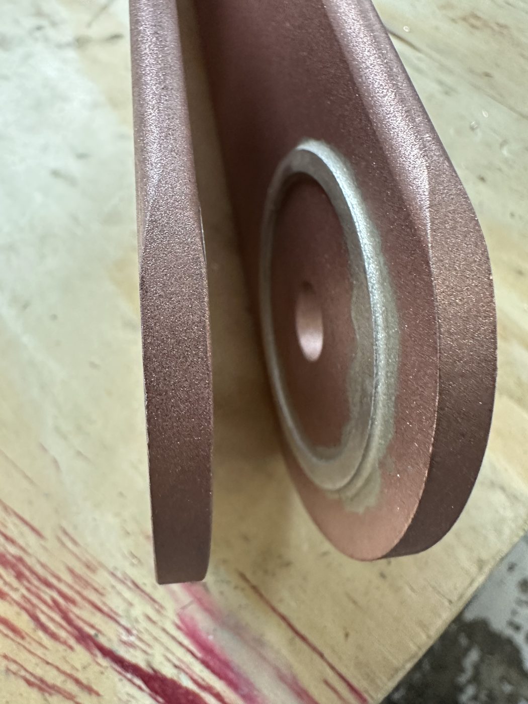 Close-up of the silver ring insert at the blade pivot point on the refurbished ConEd disconnect switch — machined silver contact visible at the blade tip boss.
