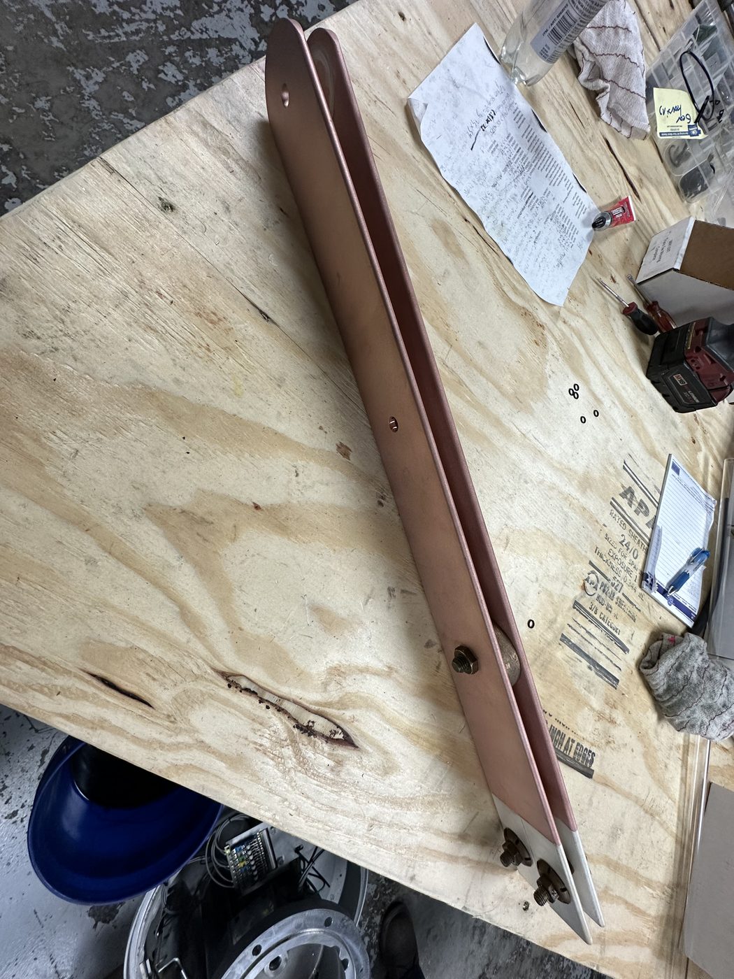 Fully refurbished ConEd disconnect switch blade arm on the workbench at Southern Switch — cleaned copper arm with silver contacts installed and all hardware replaced.