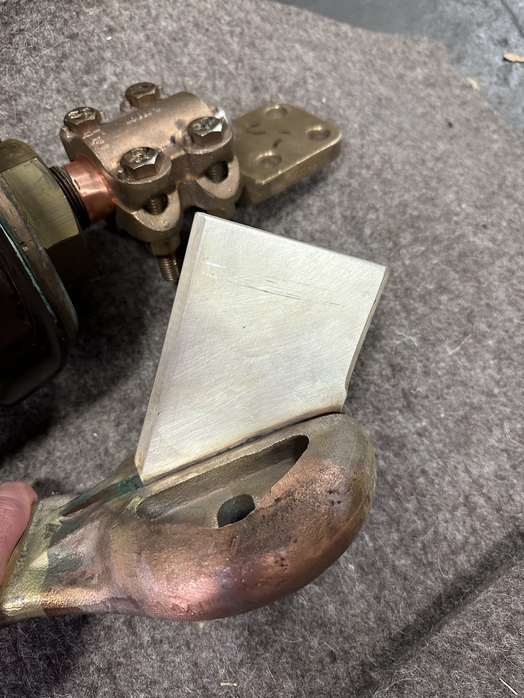 Machined silver insert plate on the stationary contact face of a refurbished ConEd distribution disconnect switch — bright silver contact surface on copper and brass assembly.