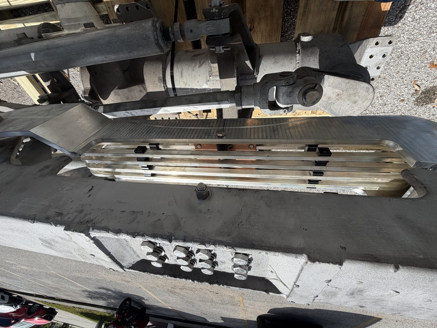 Close-up of rebuilt 500 kV pantograph switch contact assembly — new aluminum jaw with copper finger contacts, ready for reassembly.