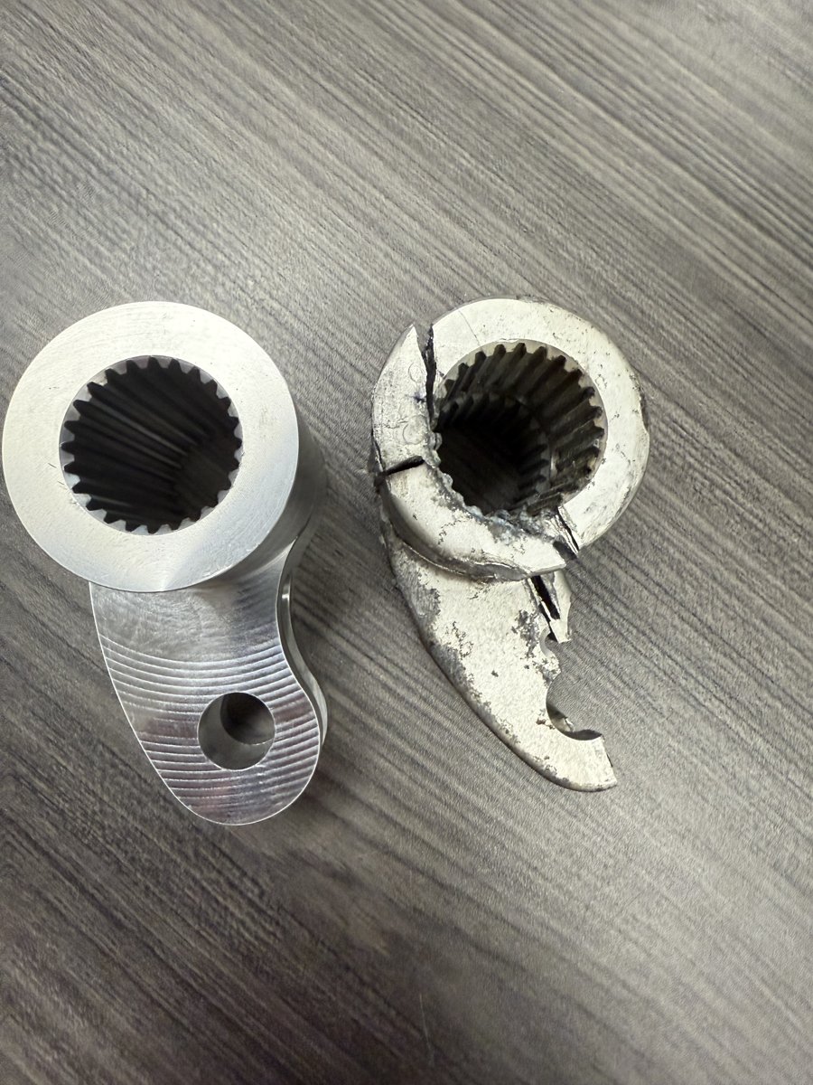 Fractured OEM cast operating-mechanism part from a Siemens SF6 breaker beside the solid-billet replacement machined by Southern Switch & Contacts