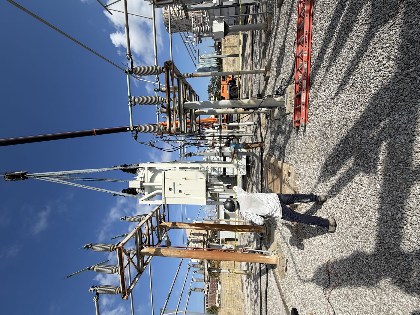 Old oil circuit breaker being lifted by crane out of a downtown Tampa TECO substation during removal. Southern Switch crew directing the lift.